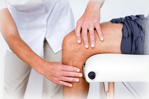 Doctor looking at knee pain
