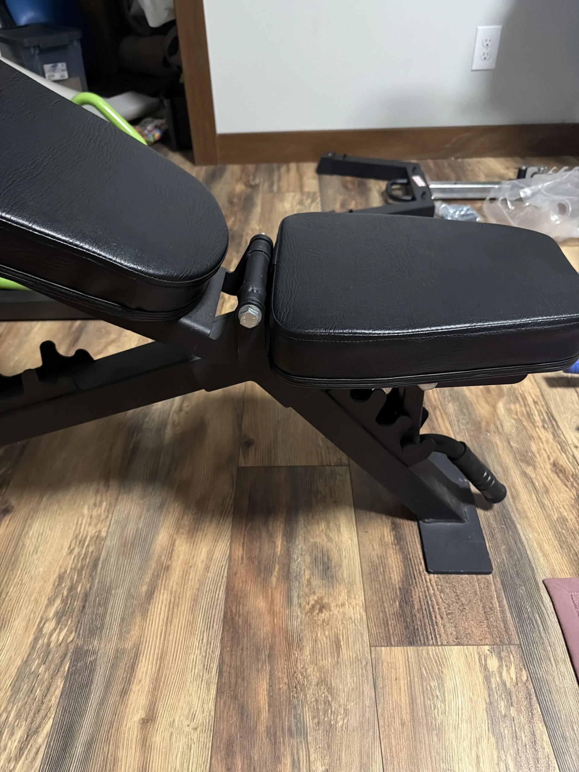 Close-up of Eric's adjustable bench showing the hinge and gap between the backrest and seat pads that he has to adjust around during dumbbell presses