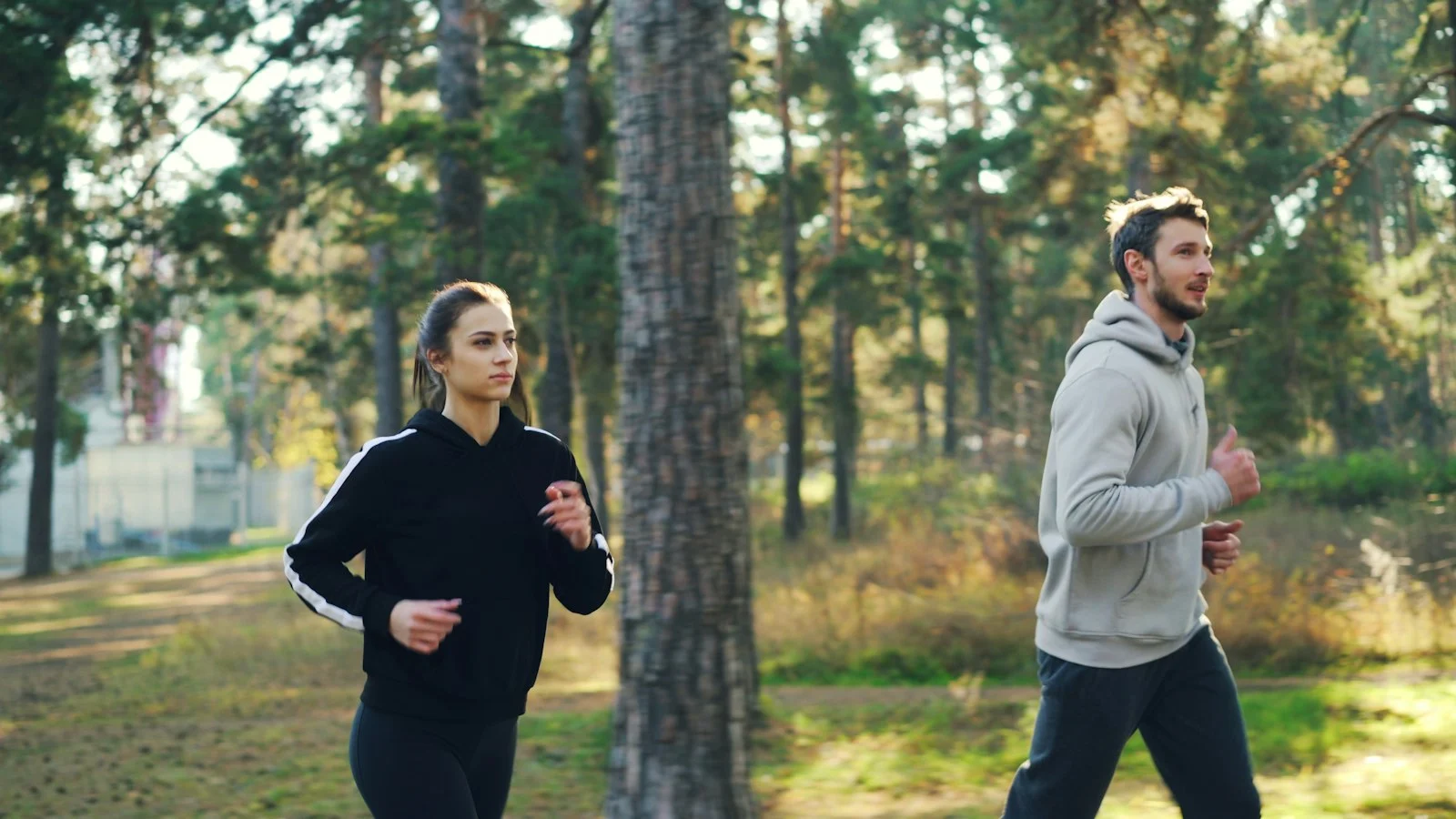 Man and woman jogging together in a park